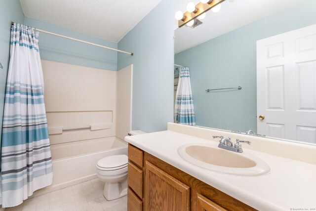 bathroom featuring toilet, shower / tub combo, and vanity