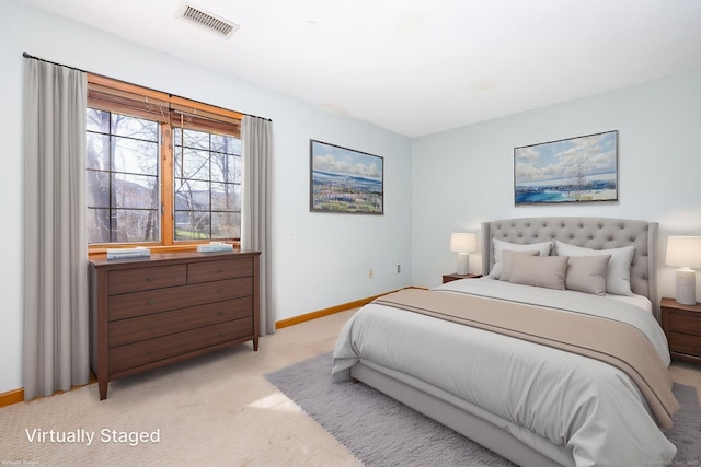bedroom featuring visible vents, baseboards, and light carpet