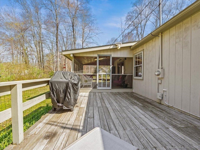 deck with area for grilling and a sunroom