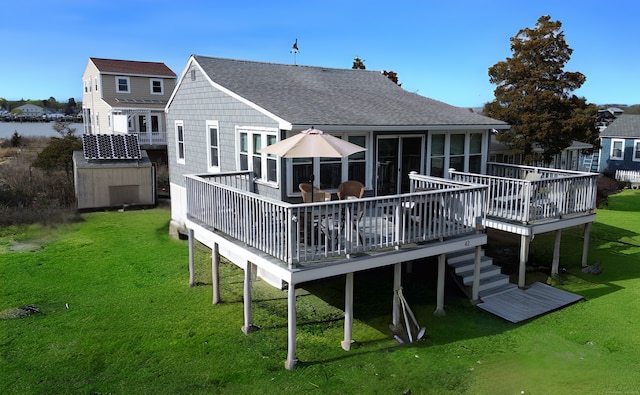 42 Central Ave, Clinton, CT 06413 - rear view of property with a wooden deck, a shingled roof, and a lawn