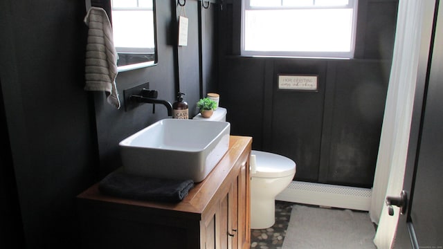 219 Forest St, East Hartford, CT 06118 - bathroom featuring vanity, toilet, and a baseboard radiator