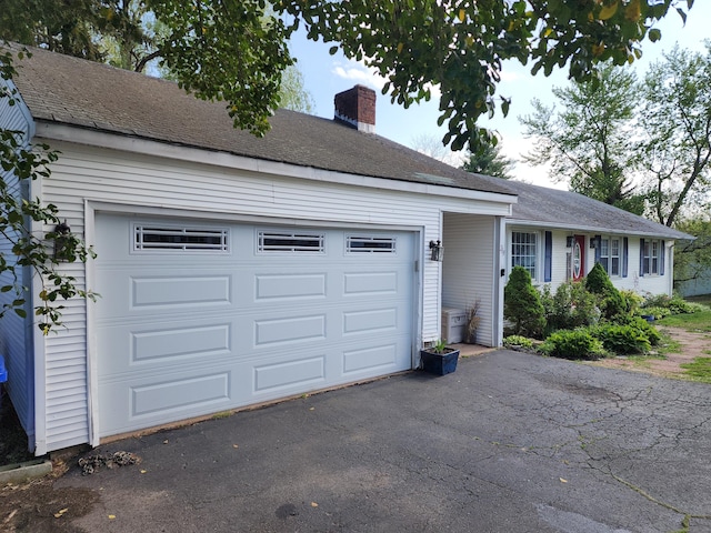 219 Forest St, East Hartford, CT 06118 - single story home featuring a chimney, driveway, and an attached garage