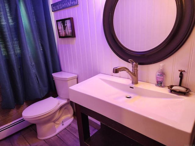 219 Forest St, East Hartford, CT 06118 - bathroom featuring a baseboard radiator, toilet, wood finished floors, and vanity