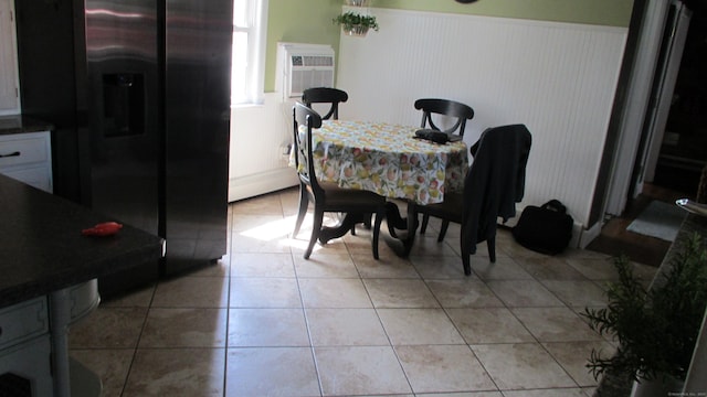 219 Forest St, East Hartford, CT 06118 - dining area featuring wainscoting, a wall mounted air conditioner, and light tile patterned floors