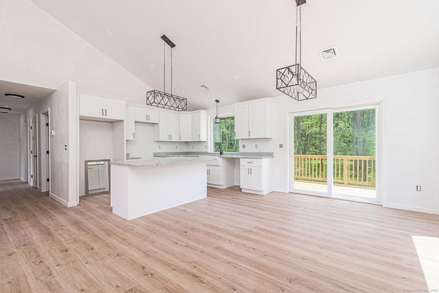 180 Tripp Hollow Rd, Brooklyn, CT 06234 - kitchen featuring high vaulted ceiling, a center island, white cabinets, light wood finished floors, and baseboards
