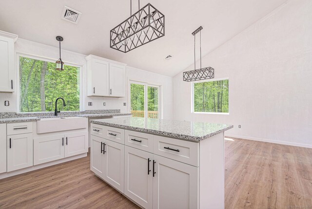 180 Tripp Hollow Rd, Brooklyn, CT 06234 - kitchen with a sink, light wood-style floors, vaulted ceiling, white cabinetry, and a kitchen island