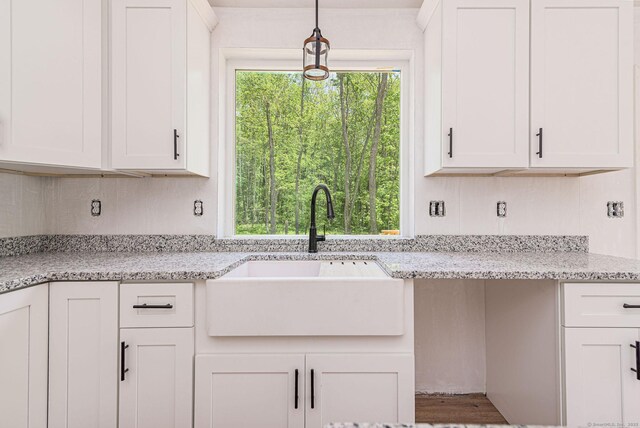 180 Tripp Hollow Rd, Brooklyn, CT 06234 - kitchen featuring a sink, white cabinets, light stone countertops, and hanging light fixtures