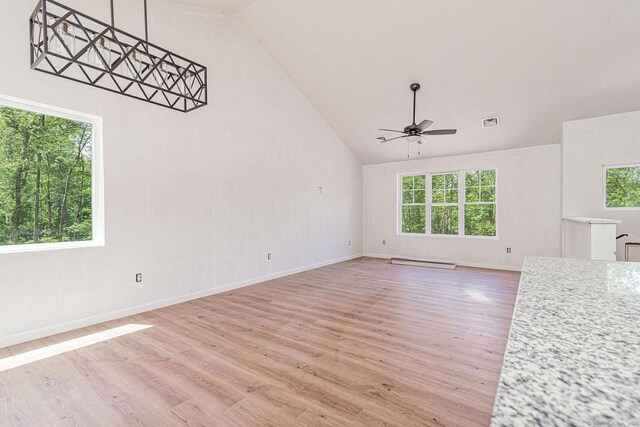 180 Tripp Hollow Rd, Brooklyn, CT 06234 - unfurnished living room featuring a ceiling fan, a baseboard heating unit, light wood-style floors, high vaulted ceiling, and baseboards