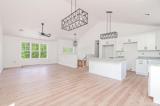 180 Tripp Hollow Rd, Brooklyn, CT 06234 - kitchen featuring a baseboard heating unit, a ceiling fan, light wood-style flooring, white cabinetry, and a kitchen island