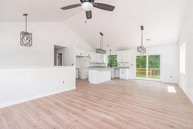 180 Tripp Hollow Rd, Brooklyn, CT 06234 - unfurnished living room with light wood finished floors, ceiling fan, high vaulted ceiling, and baseboards