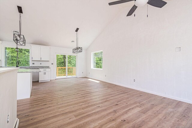 180 Tripp Hollow Rd, Brooklyn, CT 06234 - unfurnished living room featuring high vaulted ceiling, light wood-type flooring, a ceiling fan, and baseboards