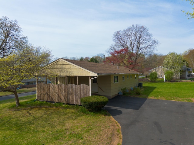 view of front of property with cooling unit and a front yard