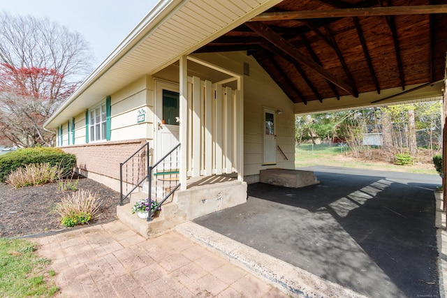 entrance to property with an attached carport