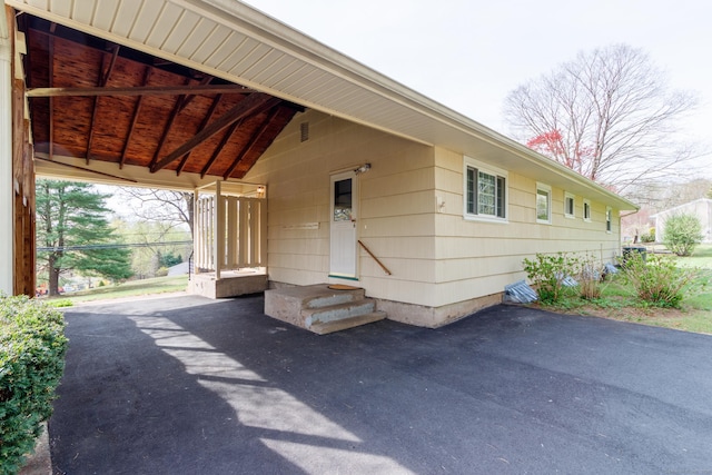 view of front of home with driveway and an attached carport