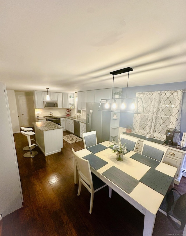 dining room featuring dark wood-style floors