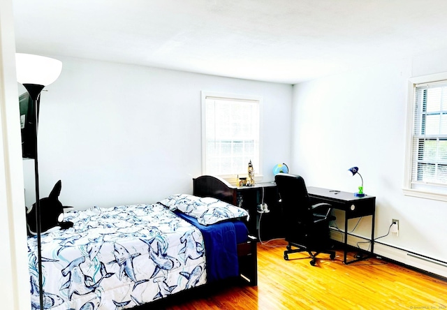 bedroom featuring wood finished floors and a desk