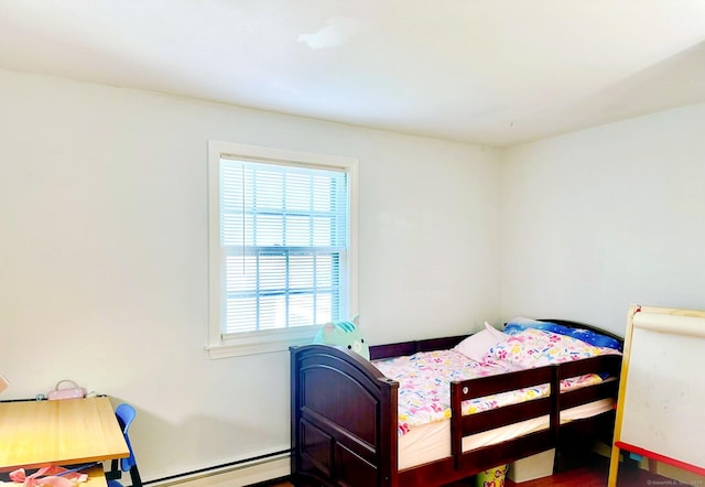 bedroom with a baseboard radiator and baseboards