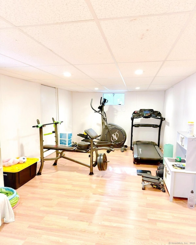 workout area featuring a drop ceiling, wood finished floors, and recessed lighting