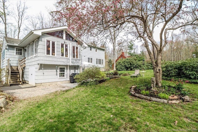 12 Winding Brook Ln, Redding, CT 06896 - back of property with a yard and stairs