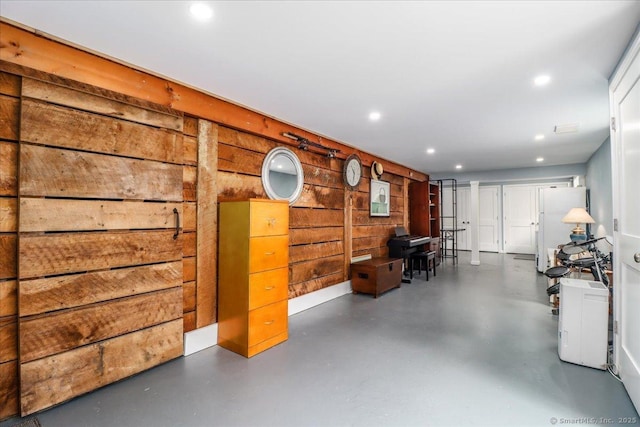 12 Winding Brook Ln, Redding, CT 06896 - basement featuring freestanding refrigerator, recessed lighting, and wooden walls