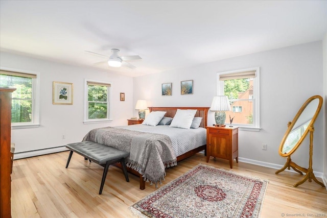 12 Winding Brook Ln, Redding, CT 06896 - bedroom featuring a baseboard heating unit, multiple windows, light wood-style floors, and ceiling fan