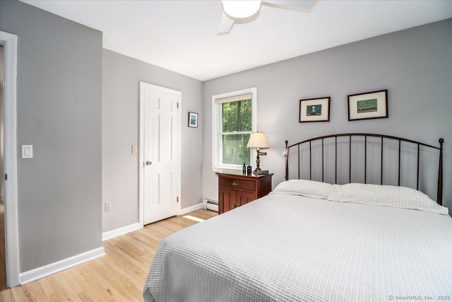 12 Winding Brook Ln, Redding, CT 06896 - bedroom featuring a baseboard heating unit, light wood-style floors, and ceiling fan