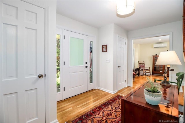 12 Winding Brook Ln, Redding, CT 06896 - entrance foyer featuring light wood finished floors and a wall mounted AC