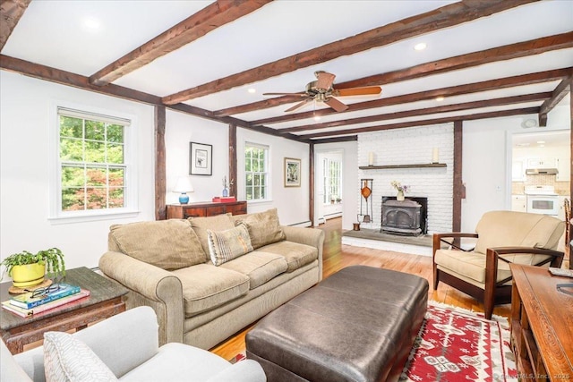 12 Winding Brook Ln, Redding, CT 06896 - living area featuring light wood-style floors, a wood stove, a ceiling fan, beam ceiling, and recessed lighting