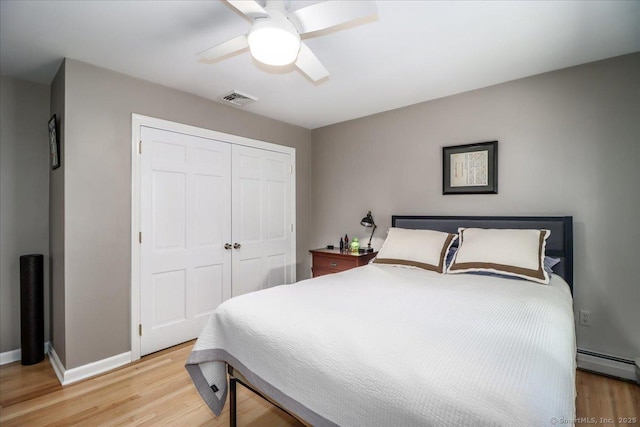 12 Winding Brook Ln, Redding, CT 06896 - bedroom featuring light wood finished floors, a closet, a ceiling fan, and a baseboard radiator
