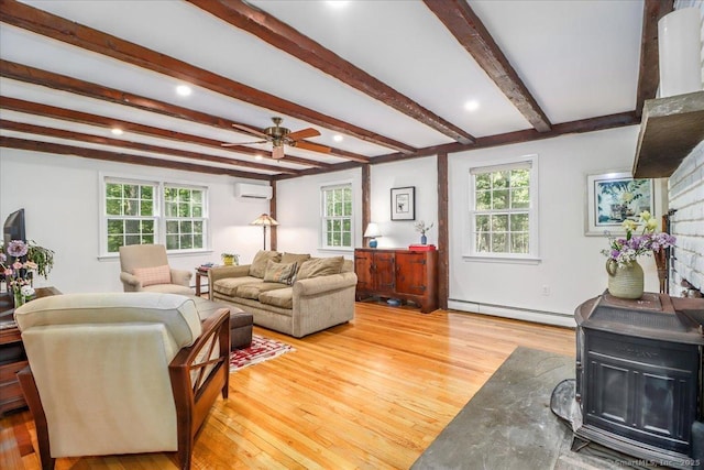 12 Winding Brook Ln, Redding, CT 06896 - living room featuring a baseboard heating unit, a wall mounted air conditioner, a wood stove, plenty of natural light, and beamed ceiling