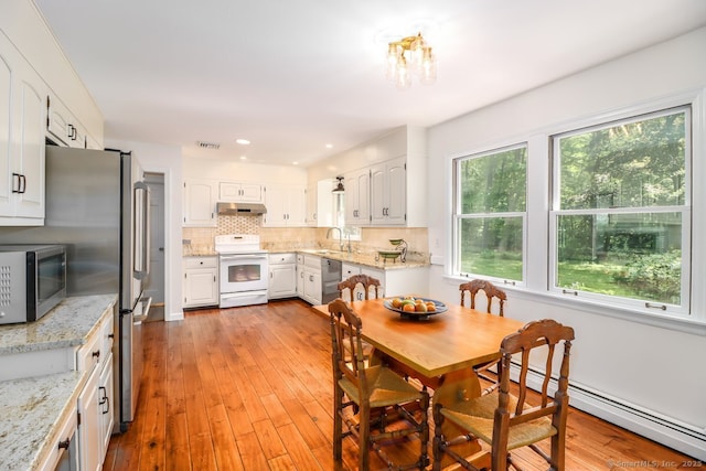 12 Winding Brook Ln, Redding, CT 06896 - dining area with a baseboard radiator, light wood-type flooring, and a chandelier