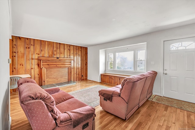 living room with wood walls and light wood-style floors