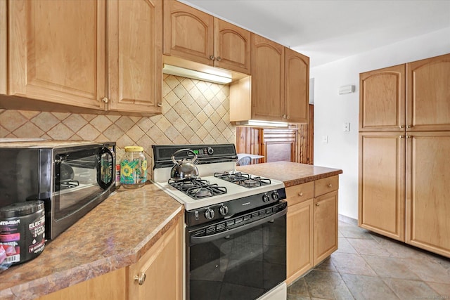 kitchen with light countertops, light brown cabinets, decorative backsplash, and gas stove