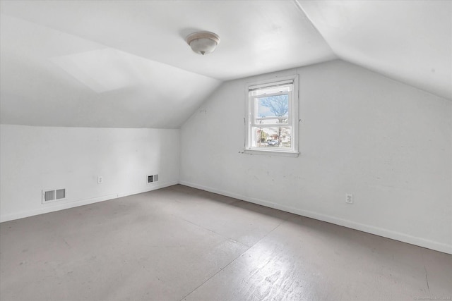 additional living space featuring visible vents, vaulted ceiling, and baseboards