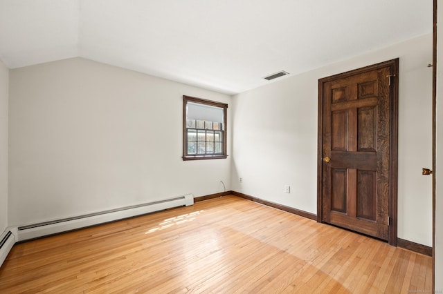 unfurnished room featuring visible vents, vaulted ceiling, baseboards, a baseboard radiator, and light wood-style flooring