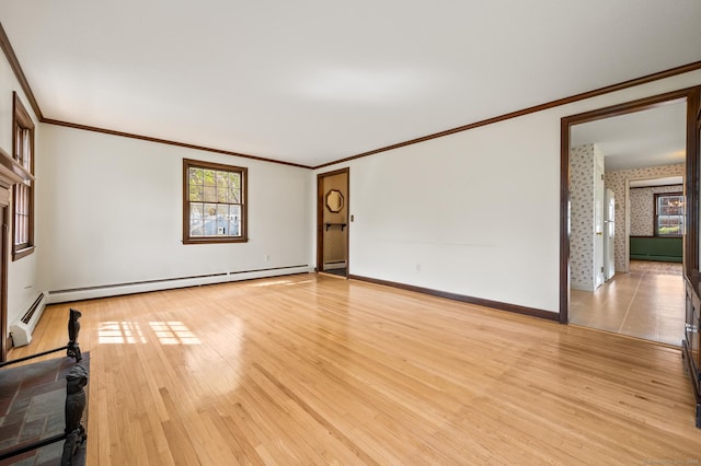 unfurnished living room with crown molding, light wood-style floors, baseboard heating, and a wealth of natural light