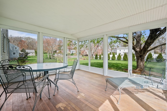 sunroom / solarium featuring a residential view and outdoor dining space