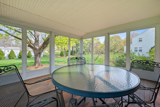 sunroom with outdoor dining area and a wealth of natural light