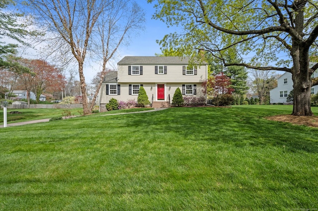 colonial-style house with a front lawn