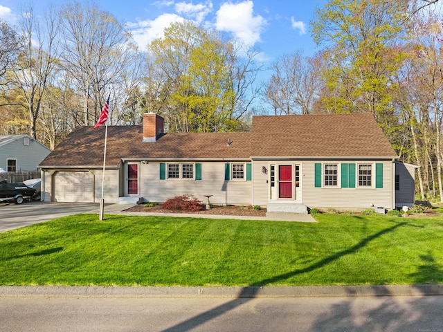 view of front of house featuring an attached garage, a chimney, asphalt driveway, and a front yard