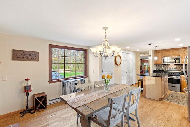 dining area with a chandelier, light wood-style floors, recessed lighting, and baseboard heating