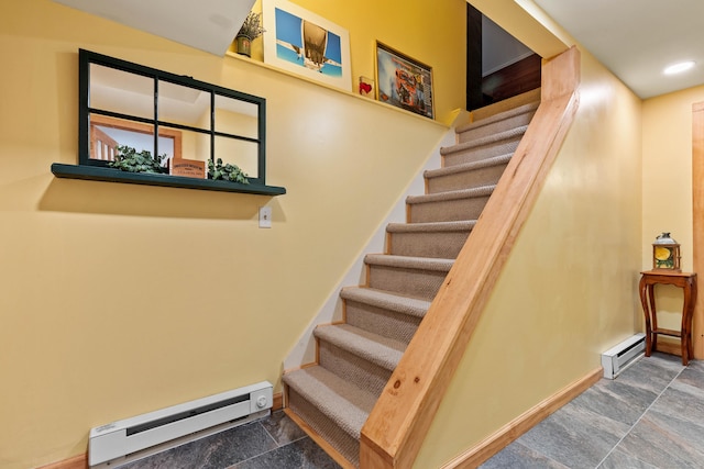 stairs featuring a baseboard heating unit, stone finish floors, and baseboards