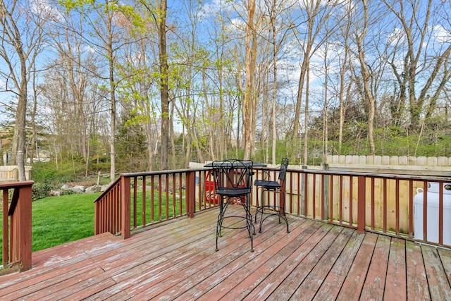wooden deck featuring a yard and outdoor dining area