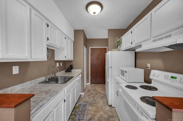 kitchen with white appliances, light countertops, white cabinets, and a sink