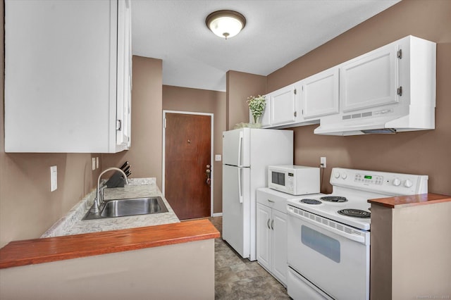 kitchen with white appliances, under cabinet range hood, light countertops, white cabinets, and a sink