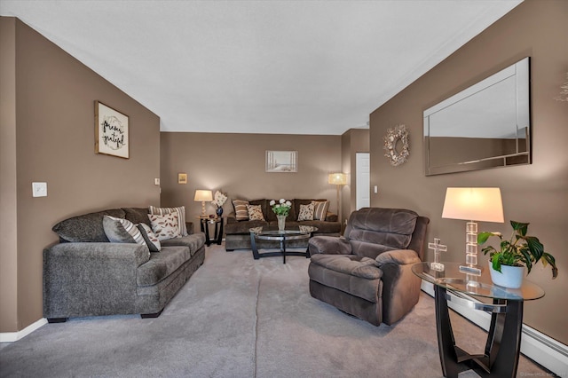 carpeted living room with baseboard heating, a baseboard heating unit, and baseboards