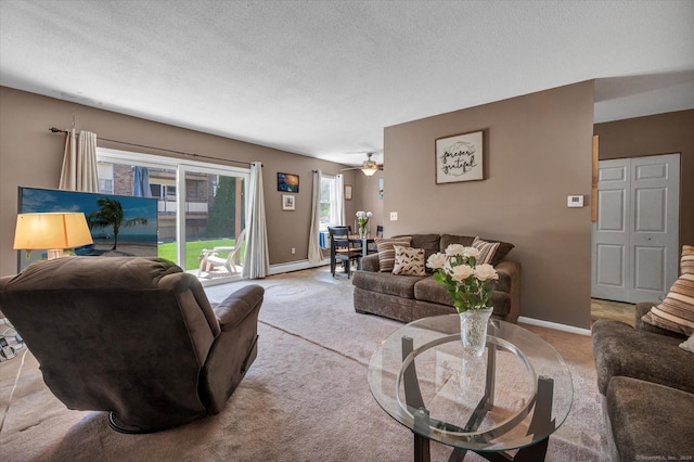living area featuring a textured ceiling, baseboards, light colored carpet, and a baseboard radiator
