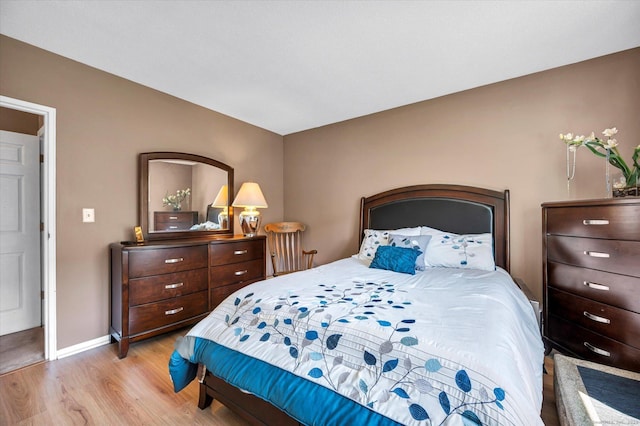 bedroom with light wood-style flooring and baseboards