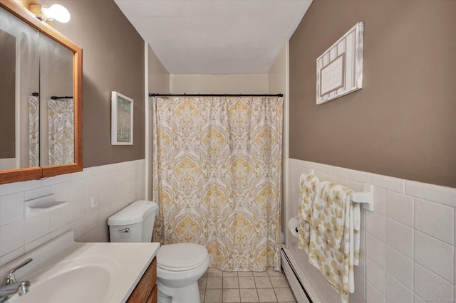 bathroom featuring a baseboard heating unit, toilet, tile walls, tile patterned floors, and wainscoting