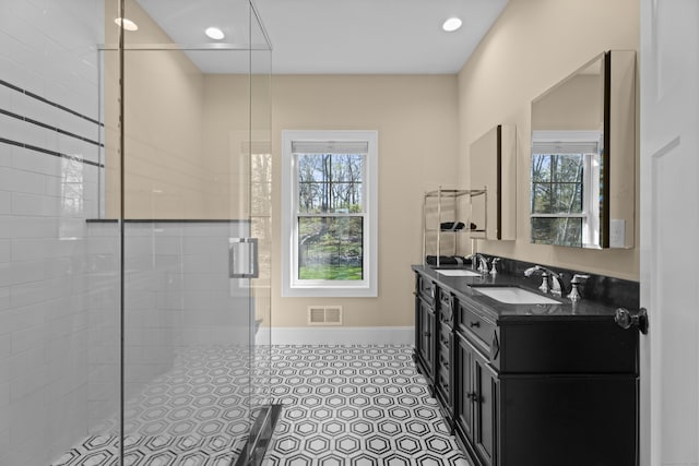bathroom featuring visible vents, a sink, and plenty of natural light